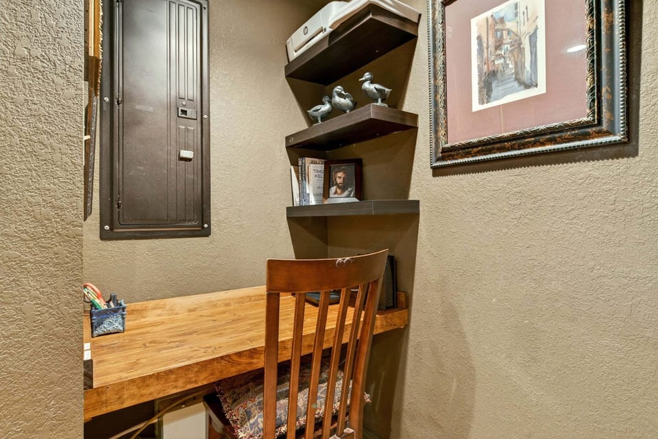 Compact, laptop-friendly desk area in the alcove off the upper den seating with the TV.