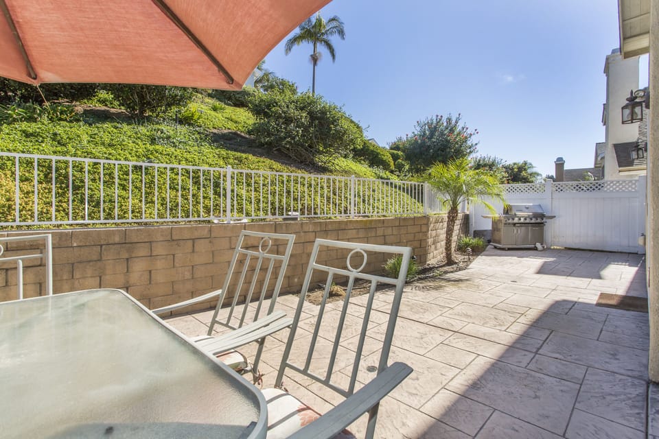 Backyard Stamped Concrete Patio with Table and BBQ
