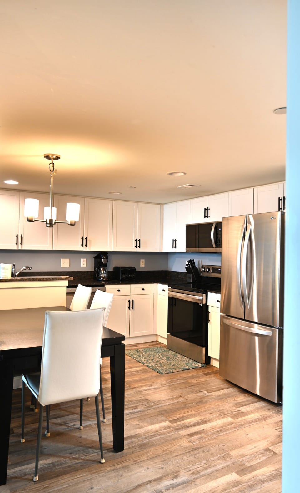 Stylish kitchen and dining space with sleek, elegant flooring.