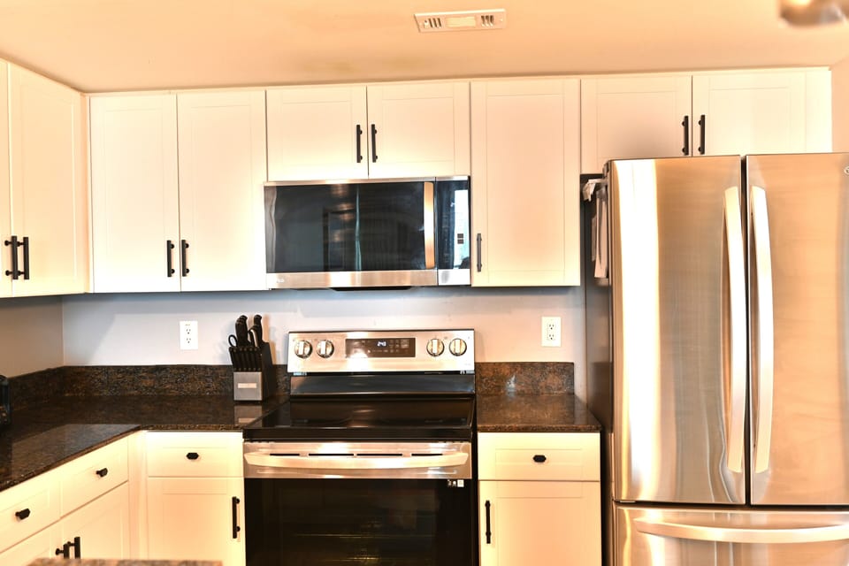Stylish, full kitchen with high-end stainless steel appliances.