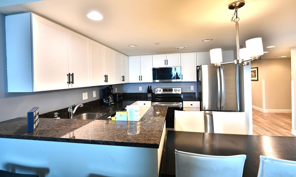 Modern kitchen with granite counters, stainless appliances, and ample storage.