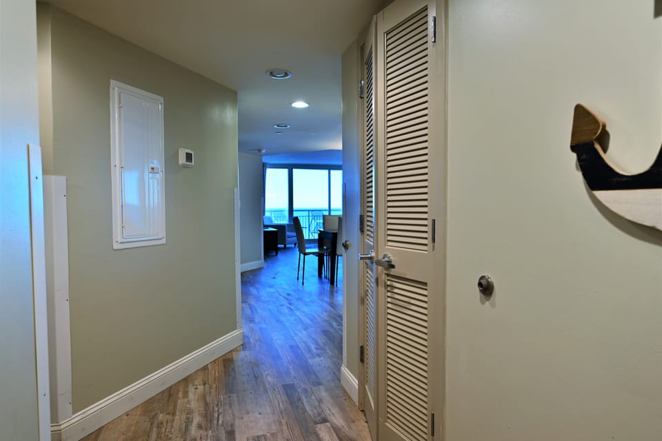 Welcoming entryway to a bright, open living space with distant ocean views.