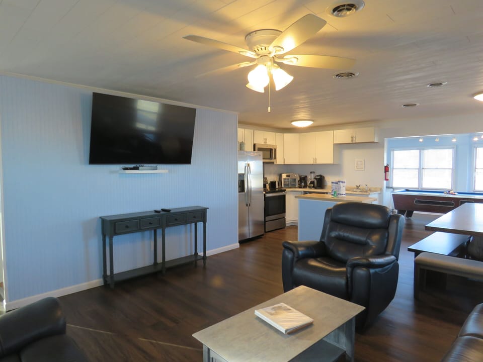 Living room has a 65in smart tv w/ cable 