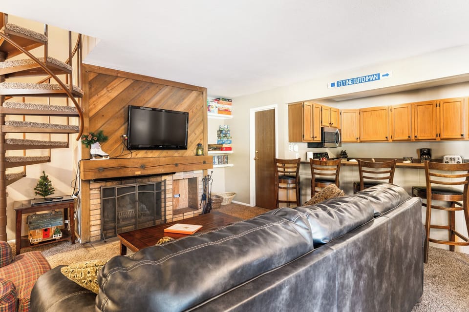 Living area with TV, ample seating, and sleeper sofa.