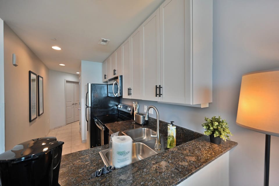 Bright, Functional Kitchen with Beautiful Cabinets and Glass Top Cooking