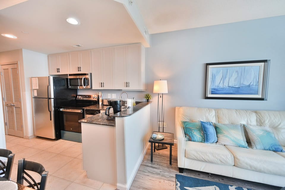 Bright living room featuring beachy accents and natural sunlight.