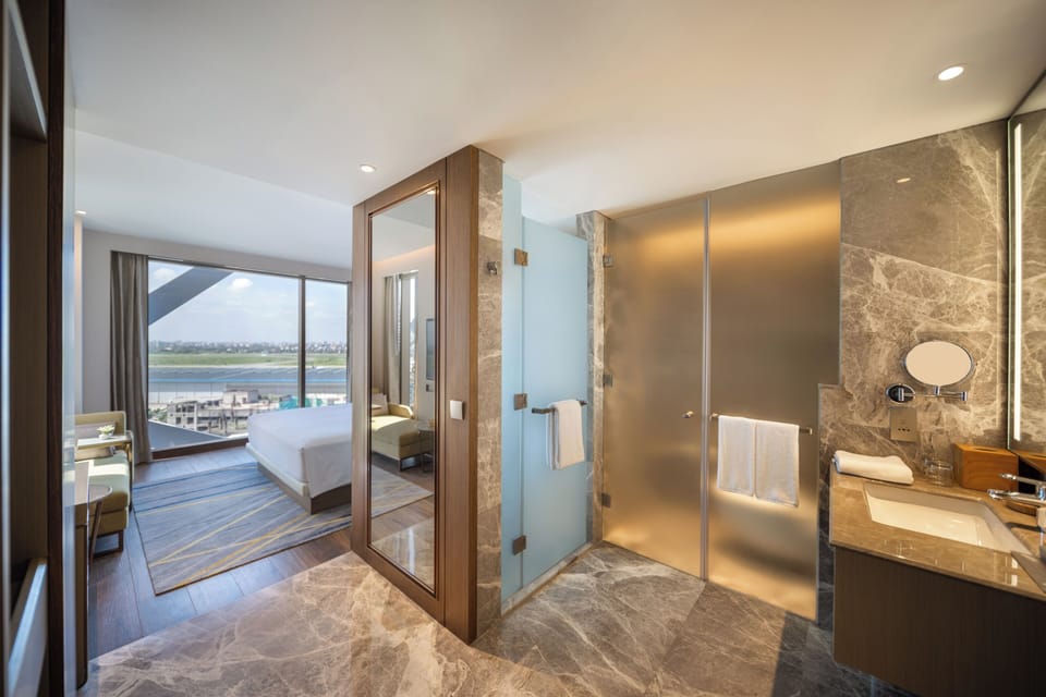 Room, 1 King Bed (Runway View) | Minibar, in-room safe, iron/ironing board, free WiFi
