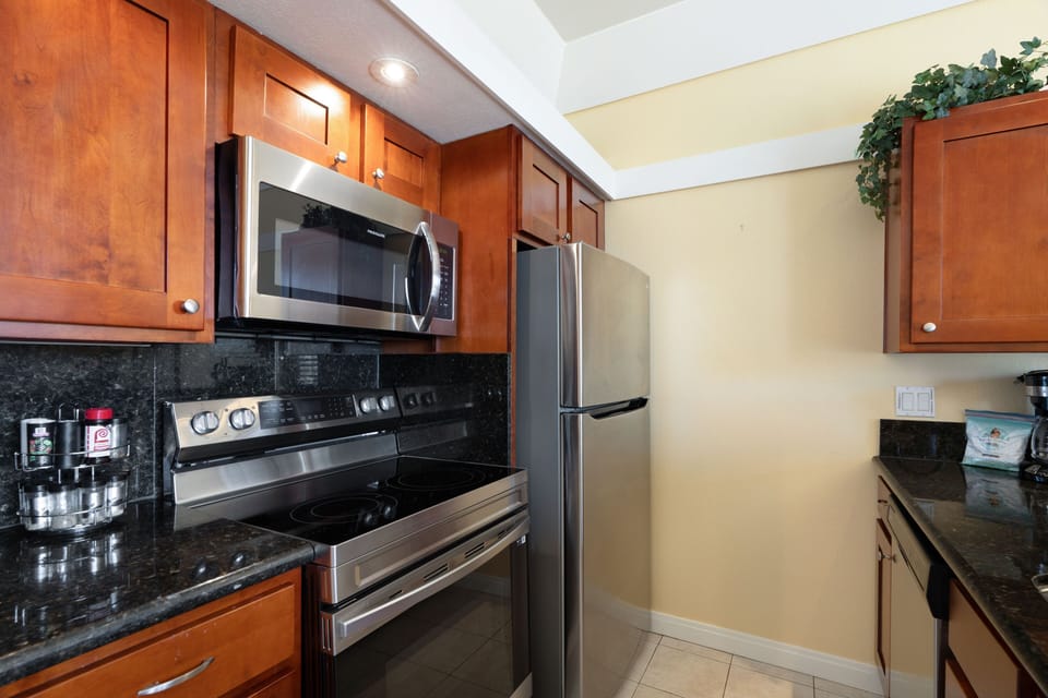 Cherry wood cabinets, stainless steel appliances, and granite counters.