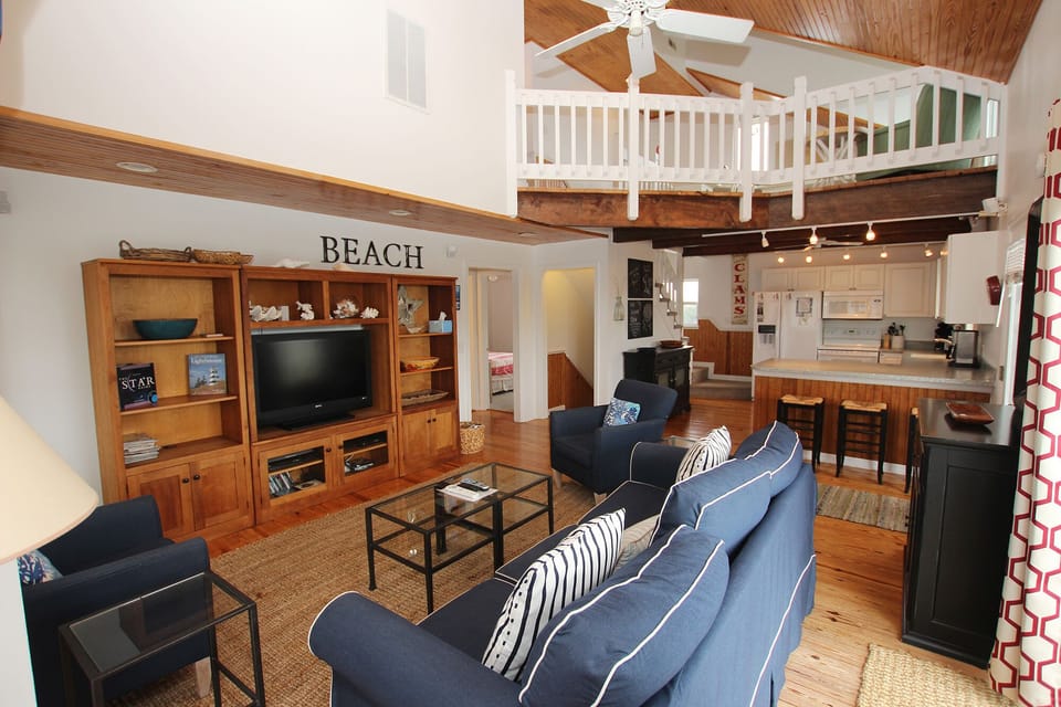 Living room and kitchen are open.  Loft upstairs is private yet connected.