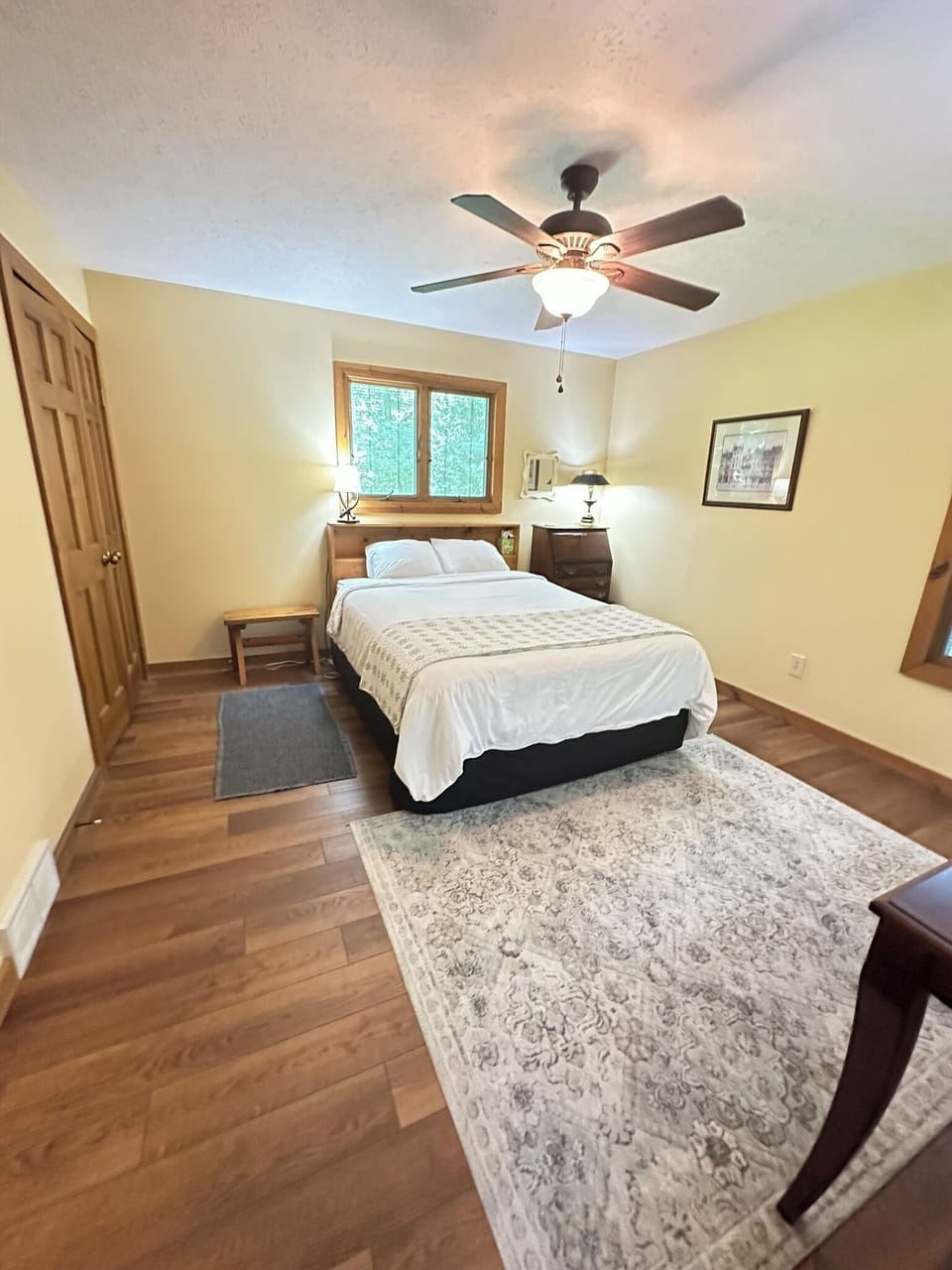 Queen sized bed in large bedroom