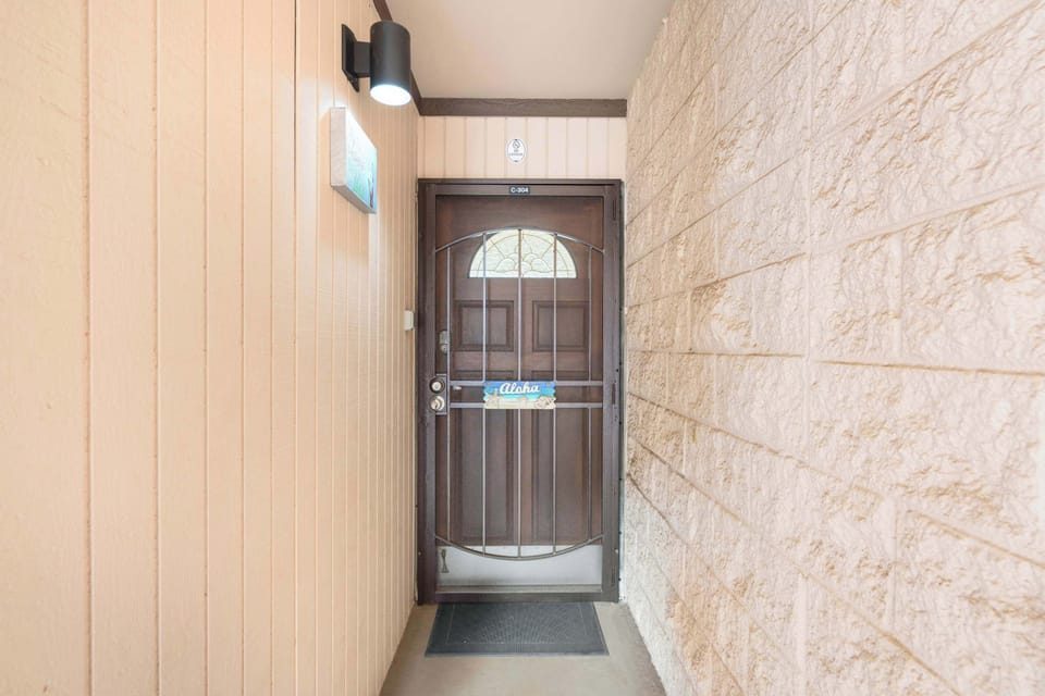 Welcome home to your private tropical getaway, featuring a secure and inviting entry alcove