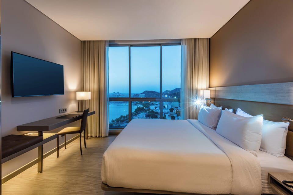 Room, 1 King Bed, City View | In-room safe, desk, soundproofing, iron/ironing board