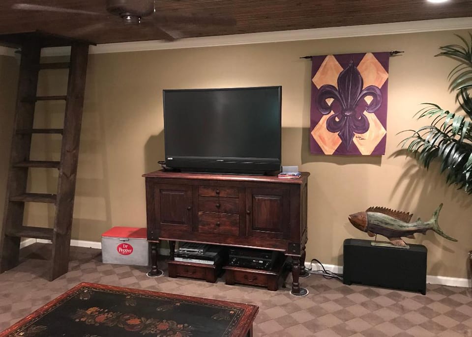 Game room/5th bedroom with wet bar and foos ball table and lake view. 