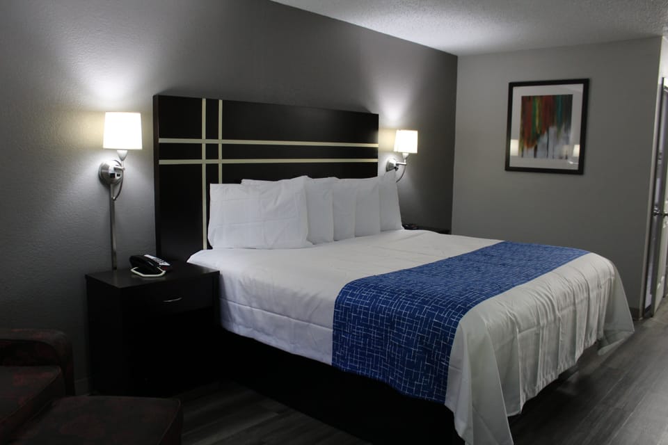 Desk, laptop workspace, blackout drapes, iron/ironing board