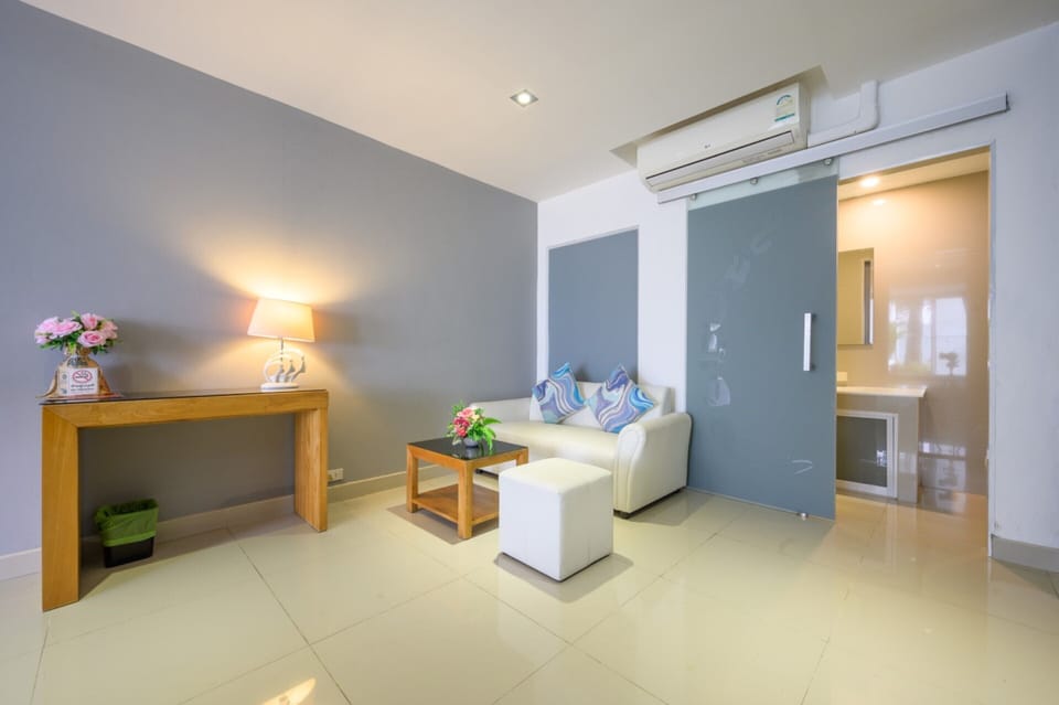 Premium Triple Room, Pool View | Living area | 32-inch LCD TV with cable channels, TV, DVD player