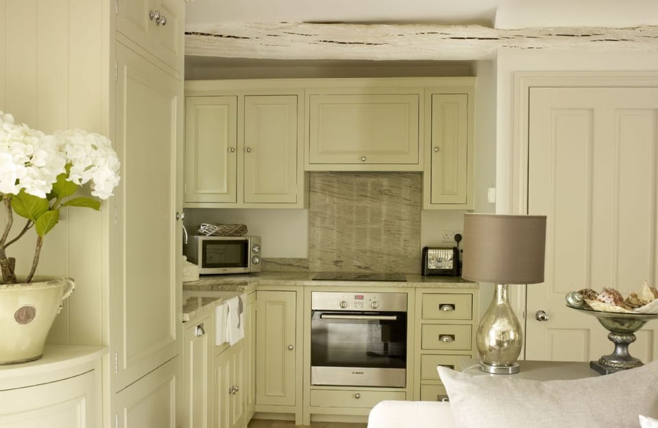 Ground floor: Open-plan New England-style kitchen and living room with limed oak floor and underfloor heating
