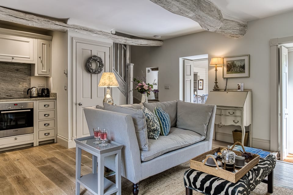 Open-plan New England-style kitchen and living room with limed oak floor and underfloor heating