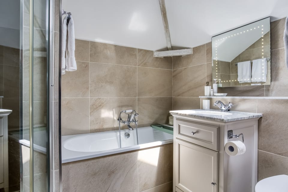 En-suite bathroom with bath and separate walk in shower