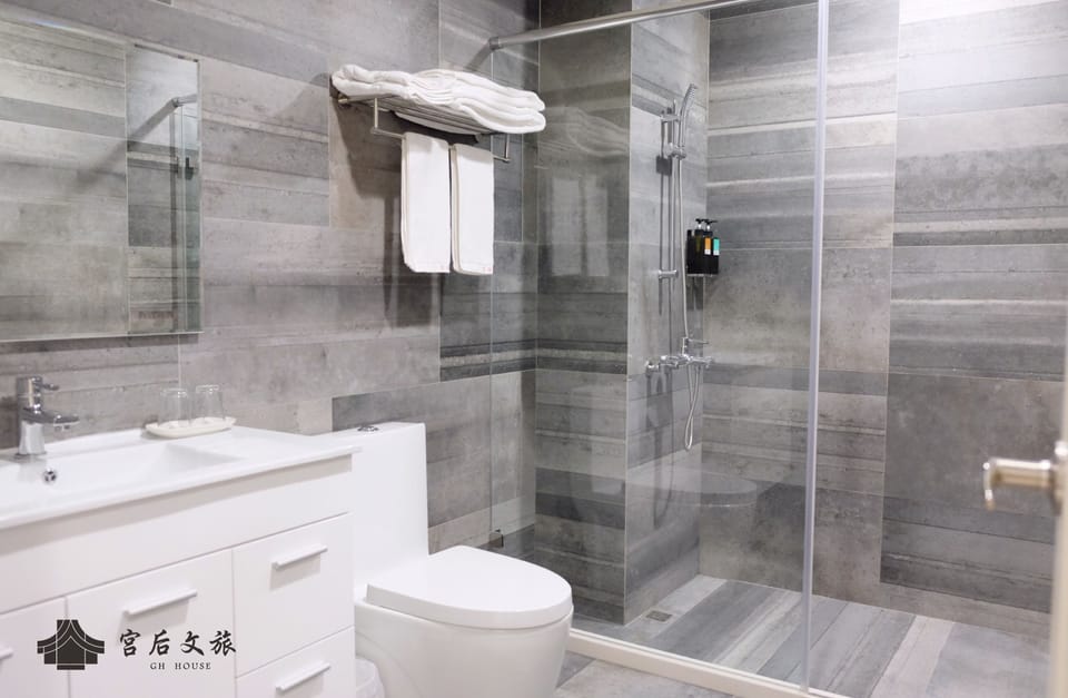 Shower, designer toiletries, hair dryer, slippers