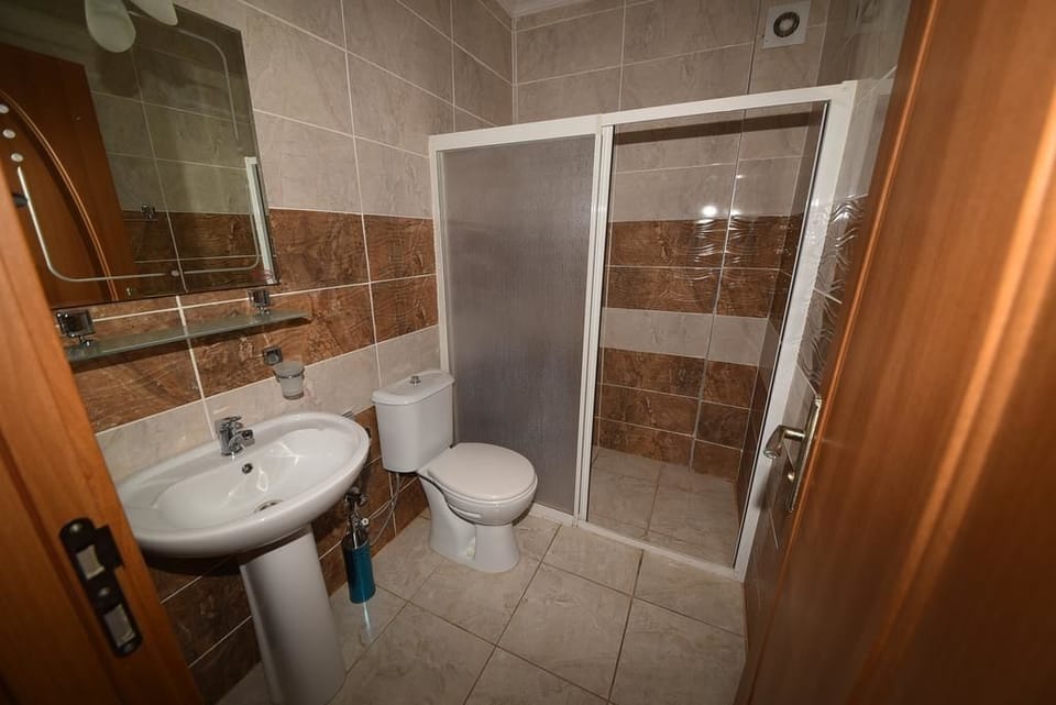 Shower, hair dryer, slippers, towels