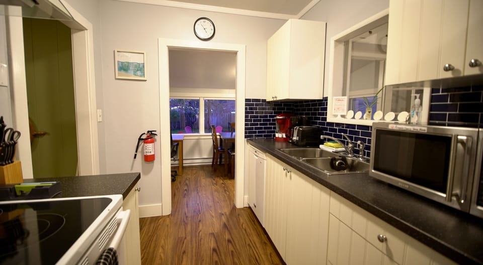 The kitchen includes double sinks, dishwasher, microwave oven