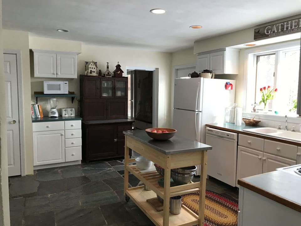 Roomy kitchen with antique Hoosier cabinet