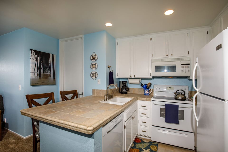 The kitchen features tumbled stone counter tops.