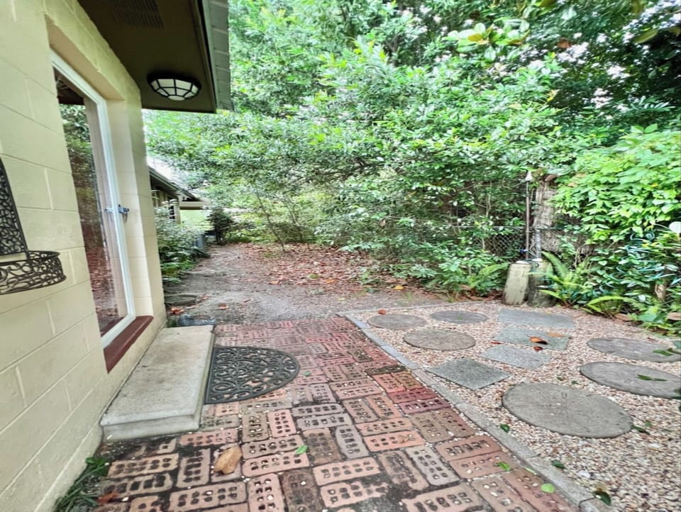 Shady & breezy fenced dog area with outdoor shower.  Gates at both ends.