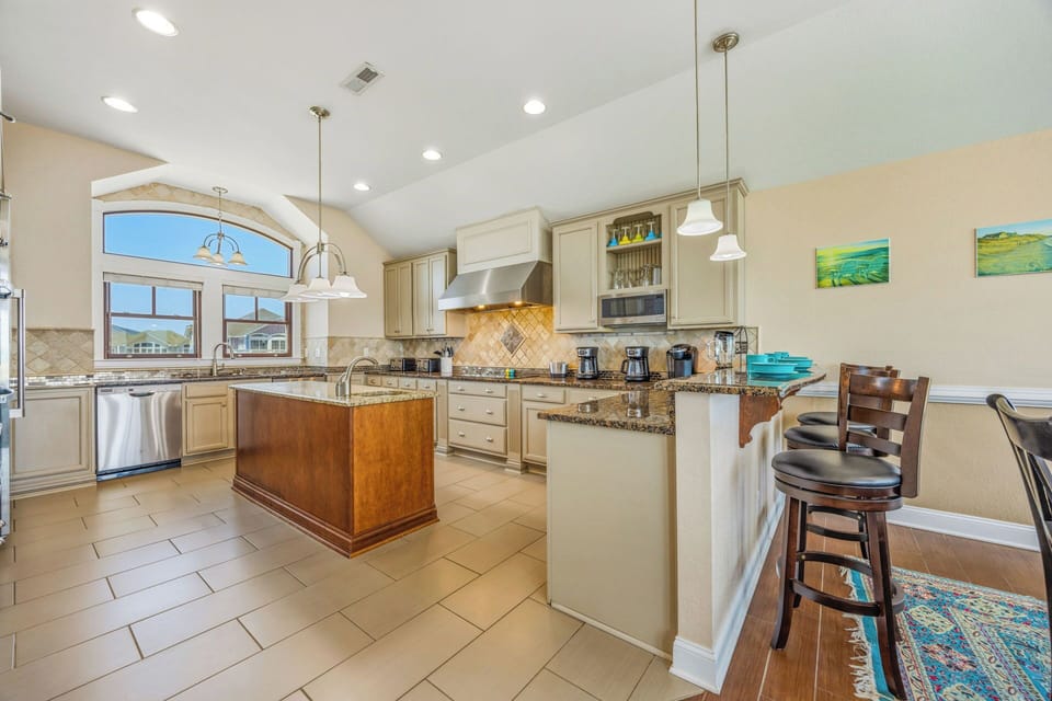 Step into your fully equipped gourmet kitchen with granite countertops, stainless appliances, and a spacious island perfect for gathering over morning coffee or evening cocktails.