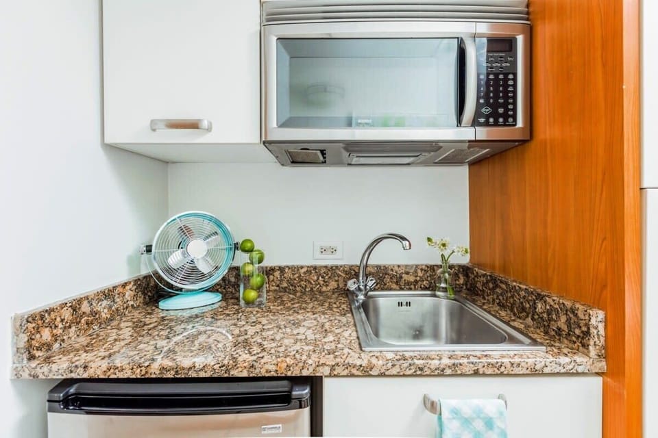 Features a kitchenette, small fridge and microwave