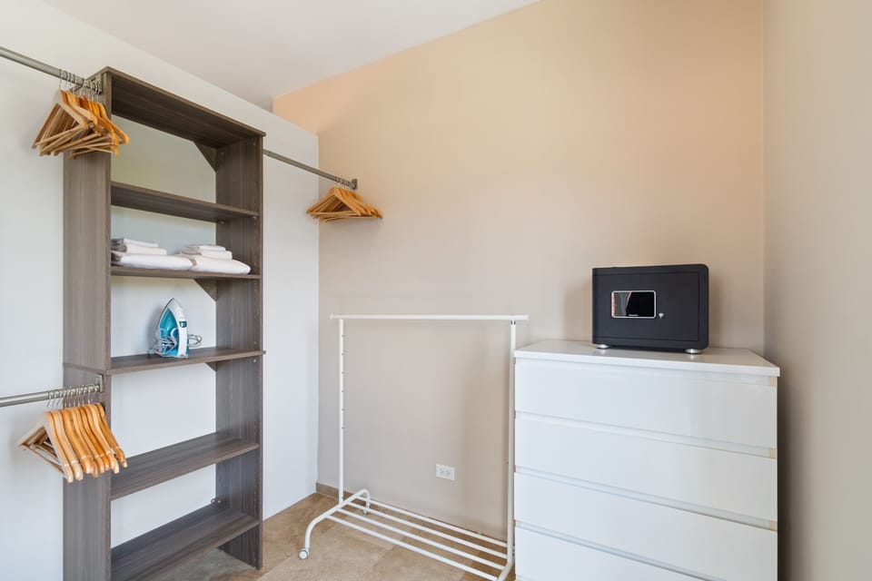 Maximize storage space while ensuring the safety of your belongings with our closet area and safe. - Experience peace of mind with our closet area complete with a secure safe for your personal items. - Spacious closet area featuring a secure safe.
