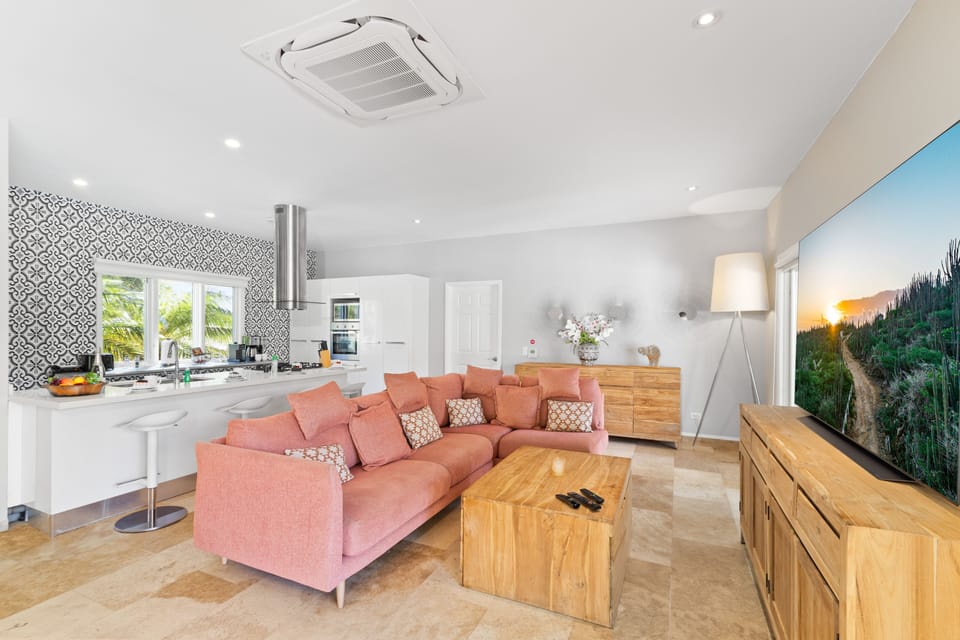 Resplendent Living Area of the Villa in Noord Aruba - Natural light floods the room, enhancing its warmth and inviting atmosphere - Smart TV and Netflix - Harmonious color scheme with pops of accent colors for visual interest