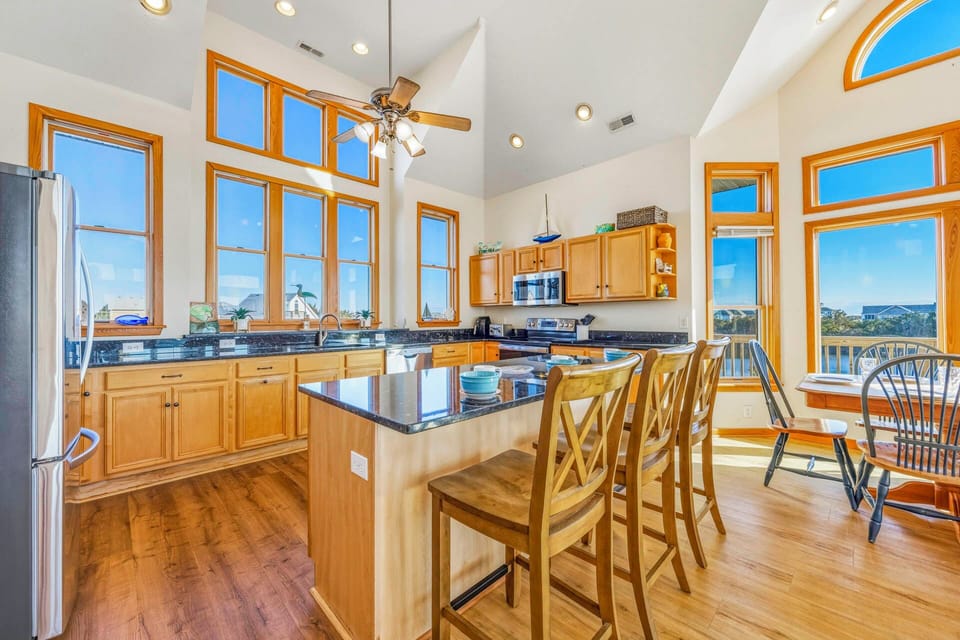 Your gourmet kitchen boasts soaring ceilings and stunning windows that flood the space with natural light while you cook.