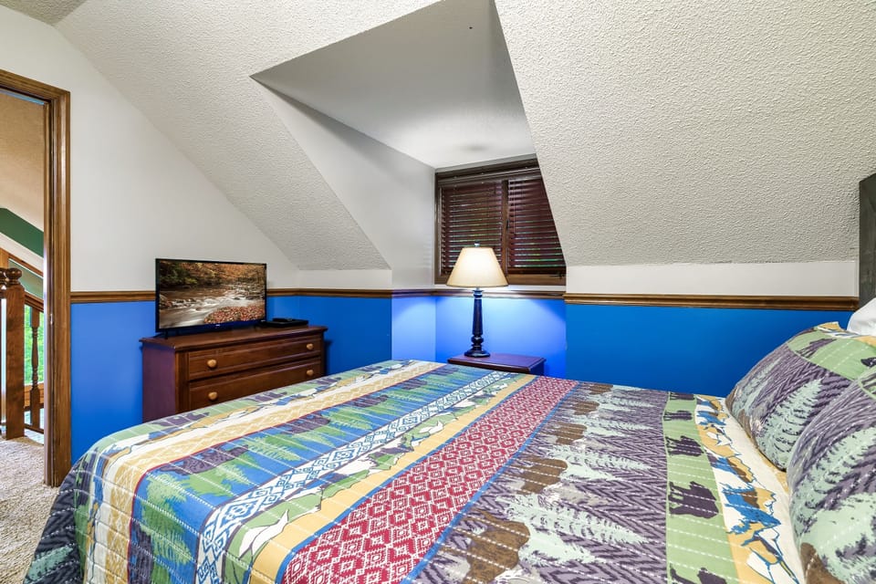 upstairs queen bedroom with TV