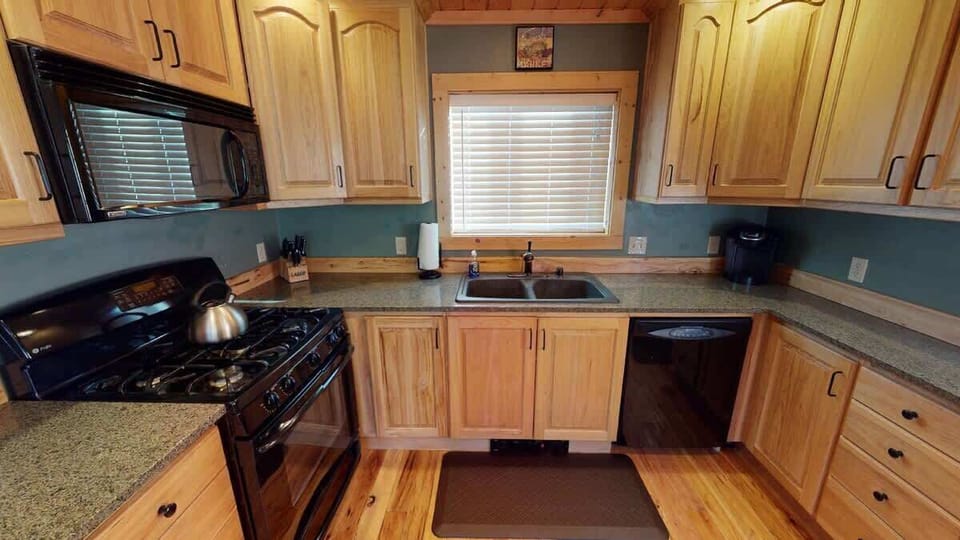 This kitchen is equipped with everything you might need to cook a home cooked meal.