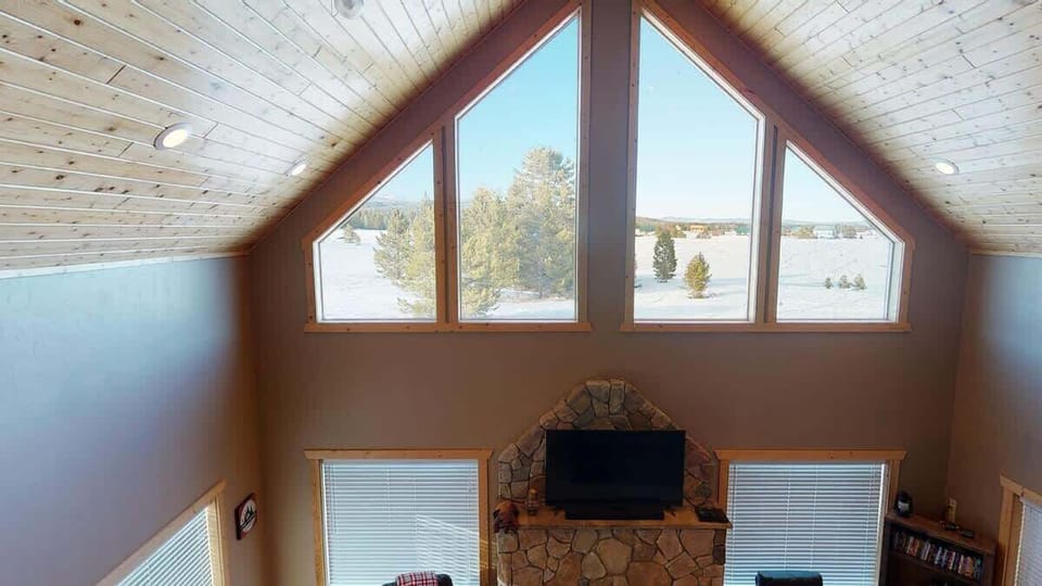 Natural light pours in through large windows, tying it all together with a view of the forest just beyond.