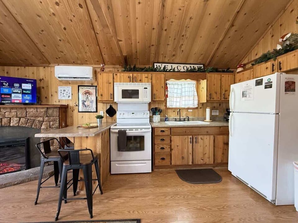 Full size kitchen with appliances, pots and pans, dishes, and cooking essentials.