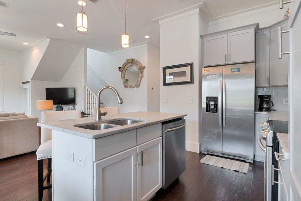Kitchen is open to living and dining area, marble counters
