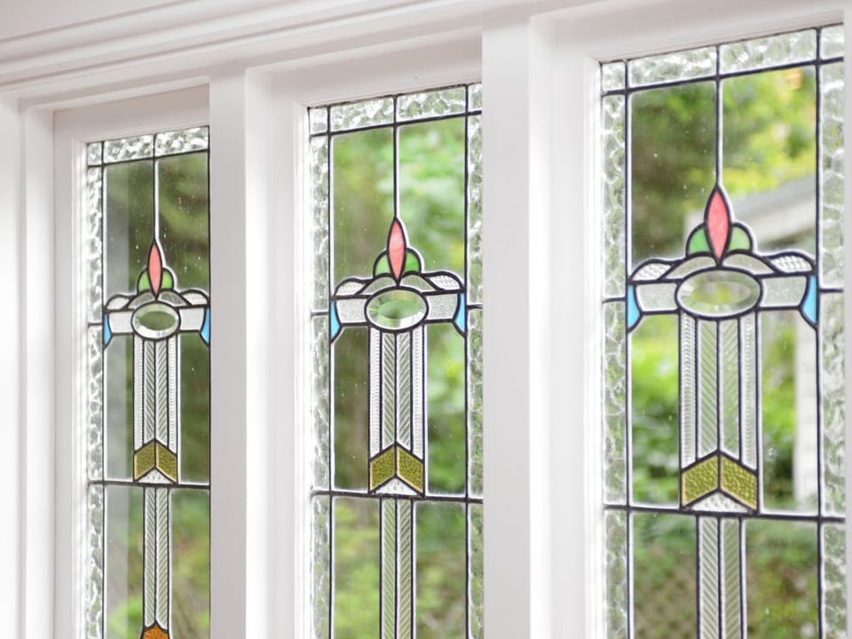 Antique stained-glass adorns the north facing windows in the lounge-room.