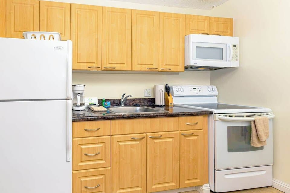 Full kitchen includes refrigerator, stove, oven, and microwave