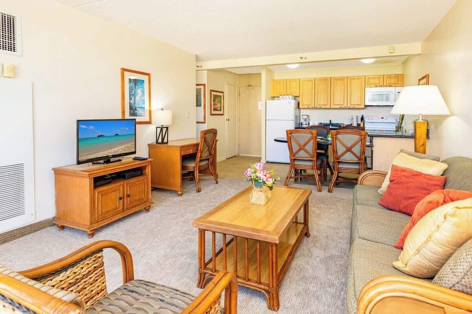 Living room with pull out sleeper sofa, TV with cable channels and desk