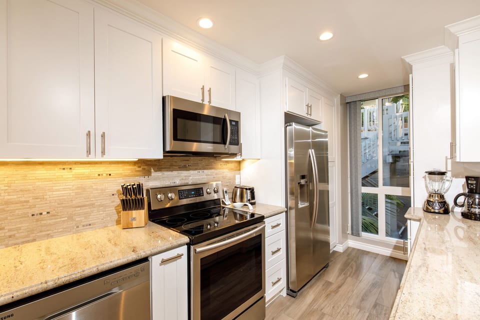 The chef's kitchen is equipped with dishes, pots and pans, and cooking utensils.