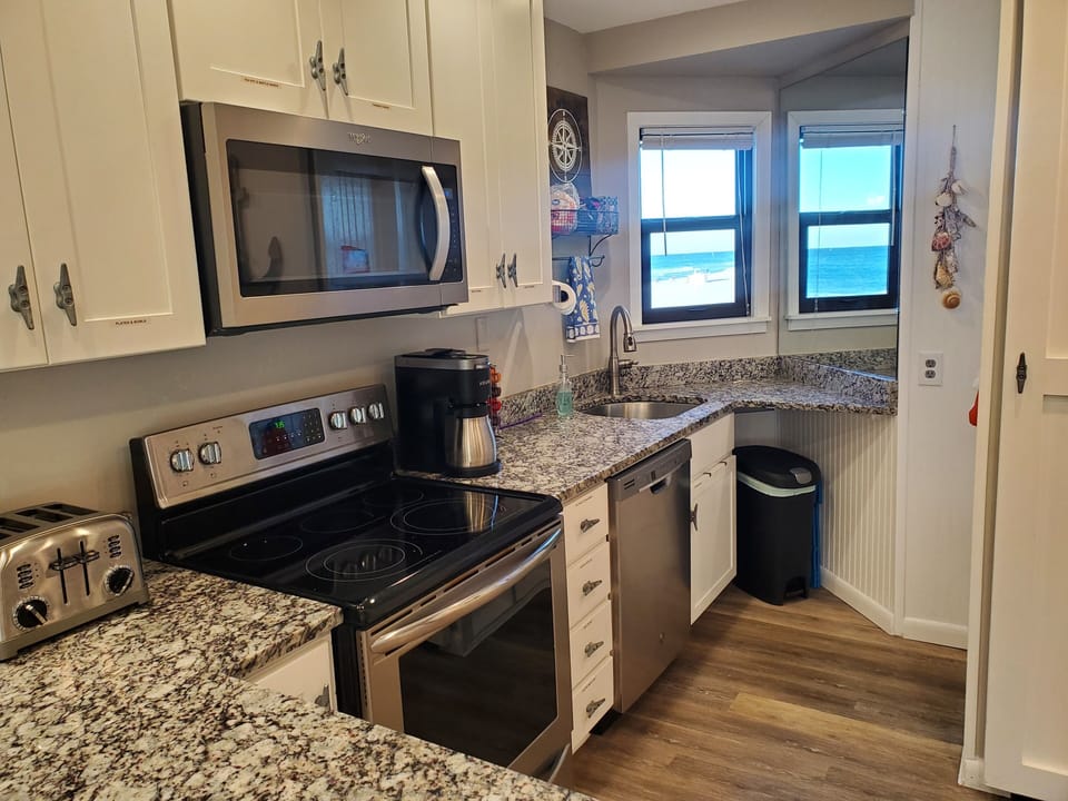 Kitchen  has all new stainless appliances and a beautiful beach view.