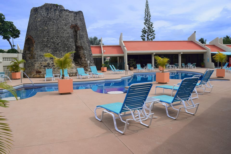 The swimming pool features the remains of a 300 year old sugar mill.
