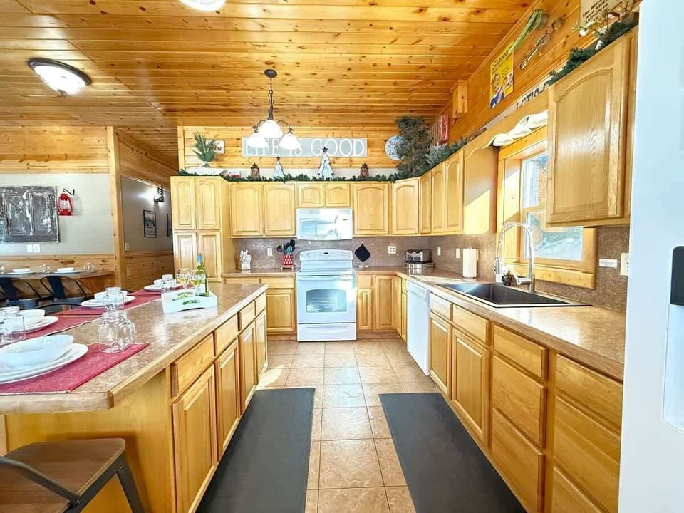 This kitchen is equipped with full appliances, basic cookware, dishes, and spices.