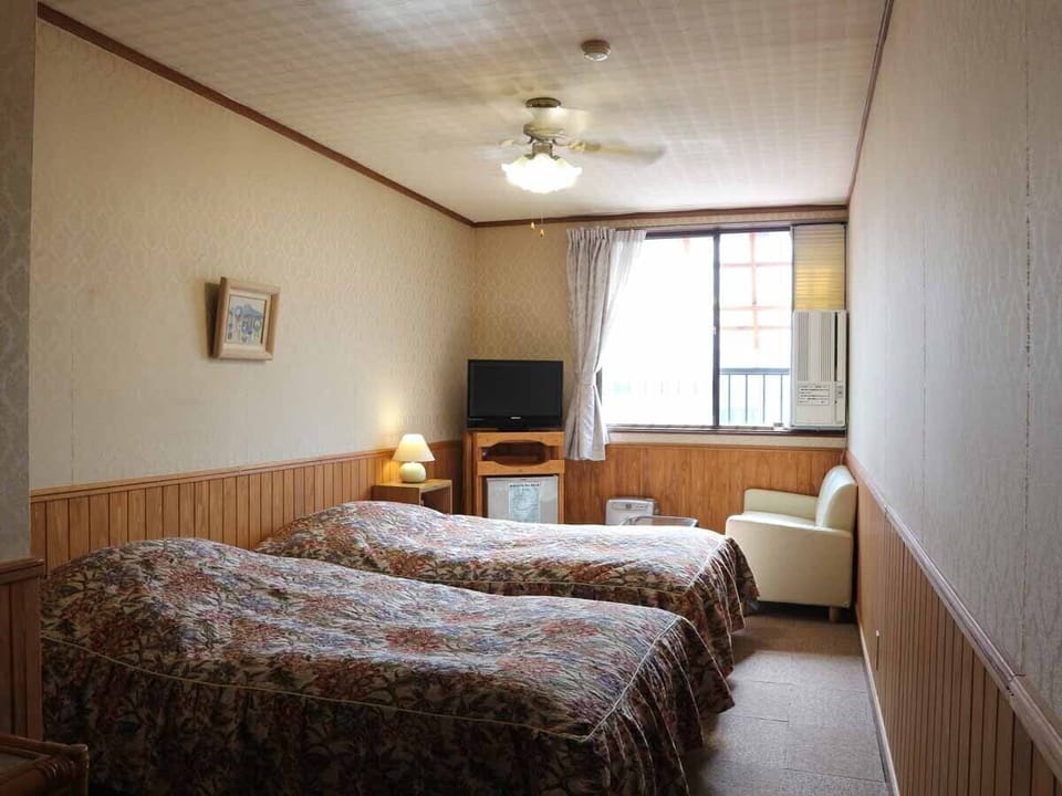 Twin Room (No Bath and Toilet) | Desk, laptop workspace, iron/ironing board, free WiFi