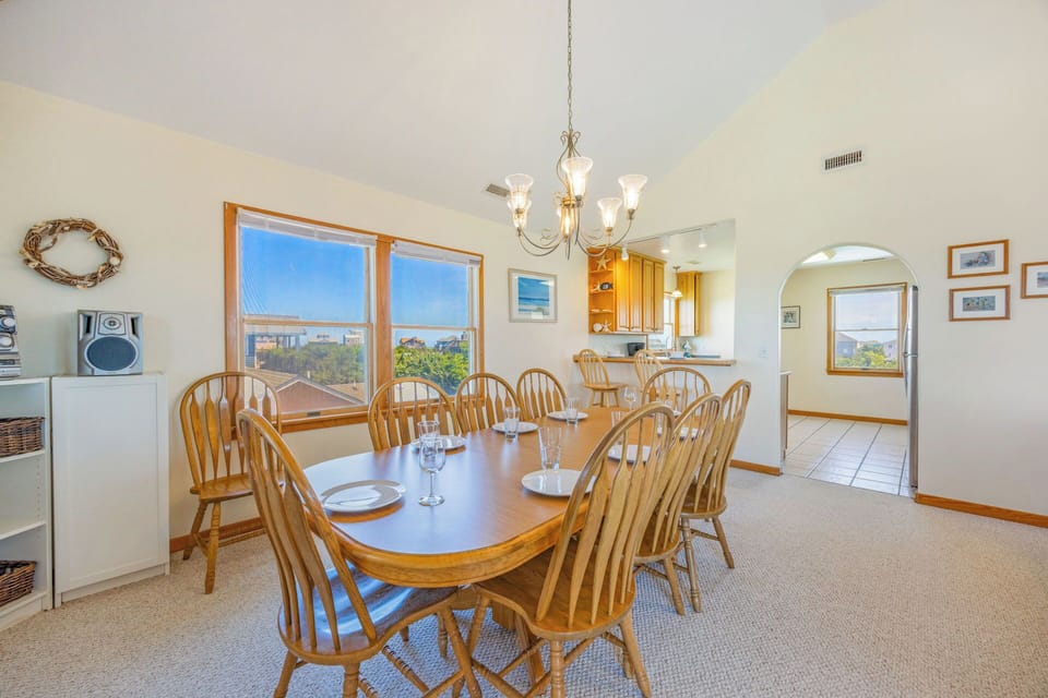 Gather your group around this spacious dining table with seating for ten, where bright coastal views and an open layout to the kitchen make every meal feel special.