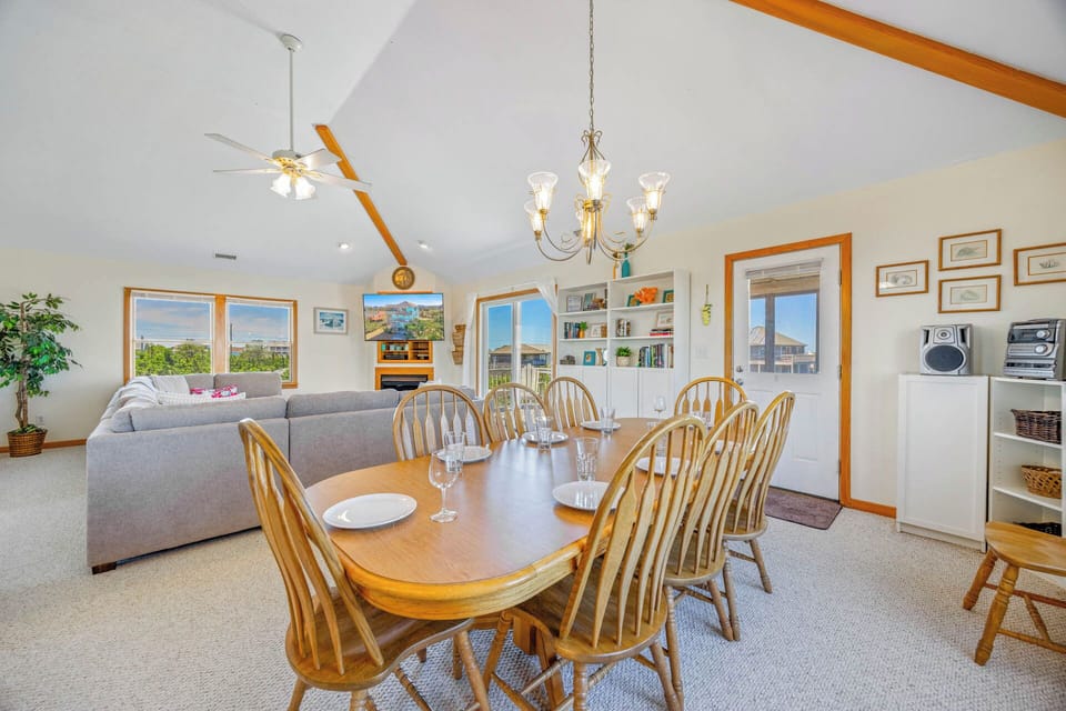 Gather around the spacious dining table where laughter flows easily, then sink into the plush sofa as natural light fills this open, vaulted retreat—your home away from home.