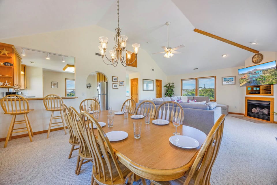 Gather around this spacious dining table where meals become memories, with your inviting living room and fully equipped kitchen just steps away—designed for effortless togetherness.