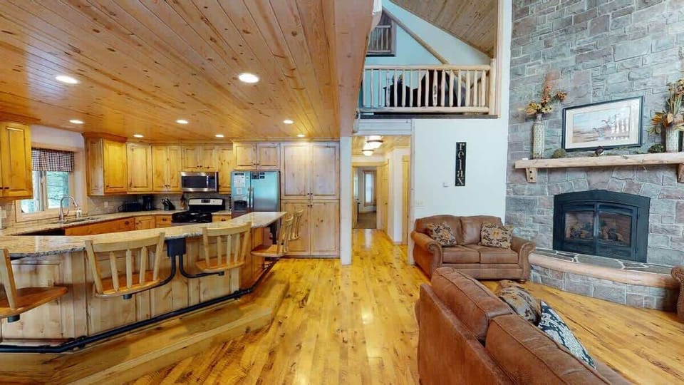The open kitchen blends seamlessly into the cabin's cozy living area, creating a welcoming space perfect for gathering and unwinding.